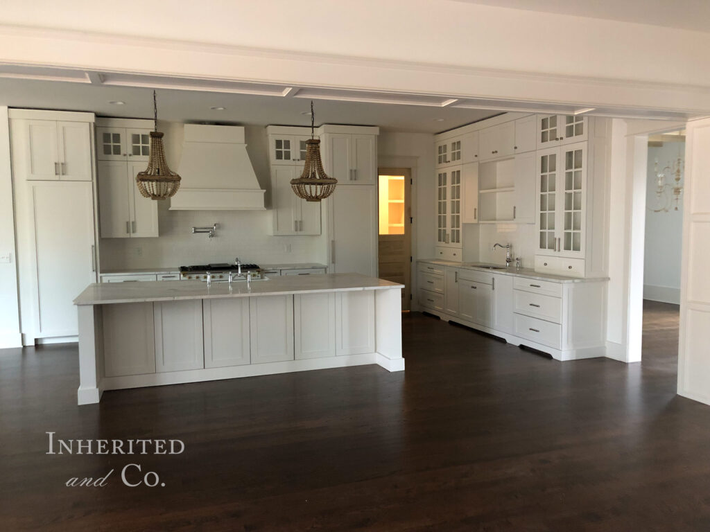 Custom kitchen with white cabinets and marble countertops in custom home