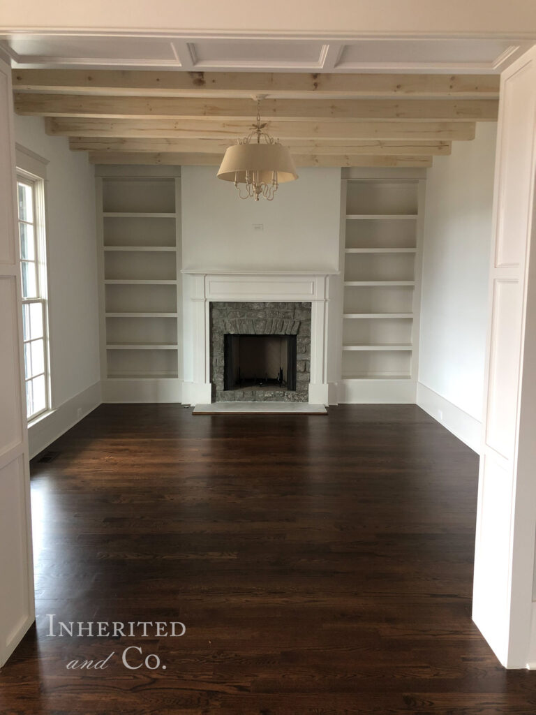Formal living room in custom home build with fireplace and built in shelving