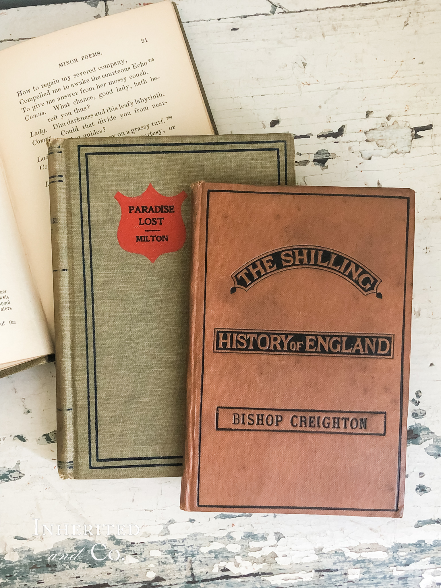 Three vintage books (Milton and History of England) on chippy white surface