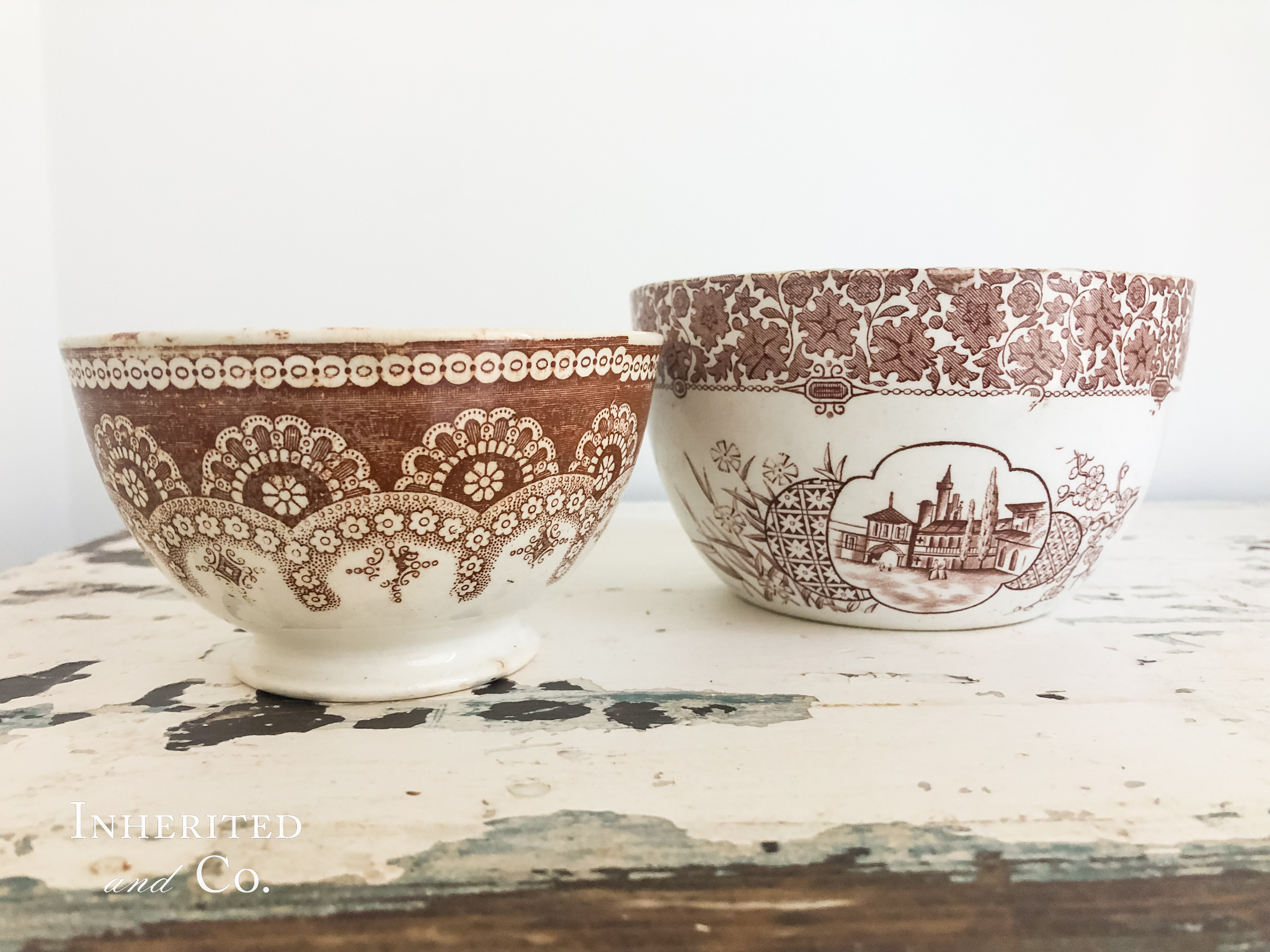 Two brown transferware bowls on chippy white surface