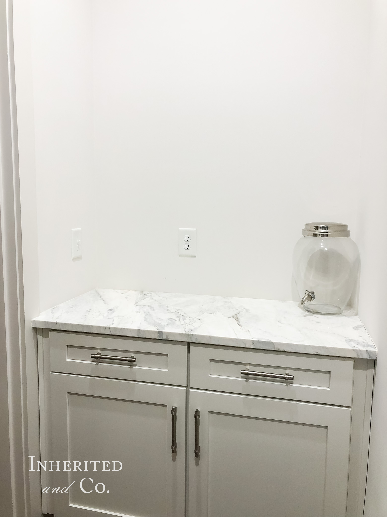 white base kitchen cabinet with marble countertop