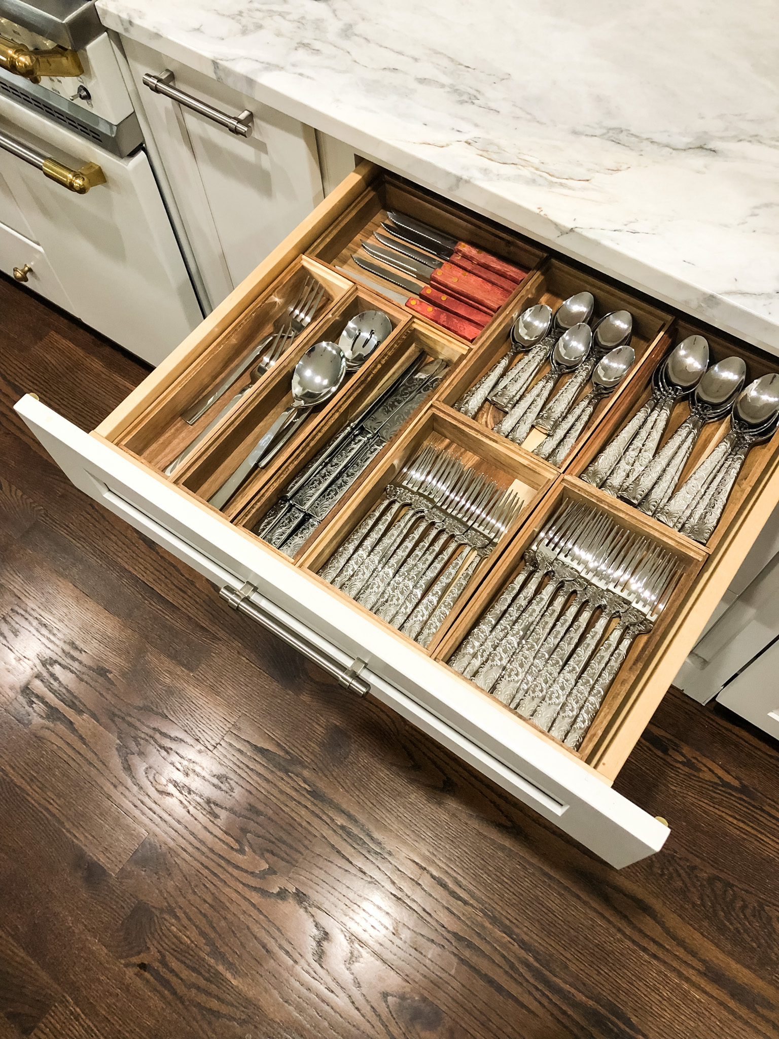 open and organized flatware drawer with wooden containers
