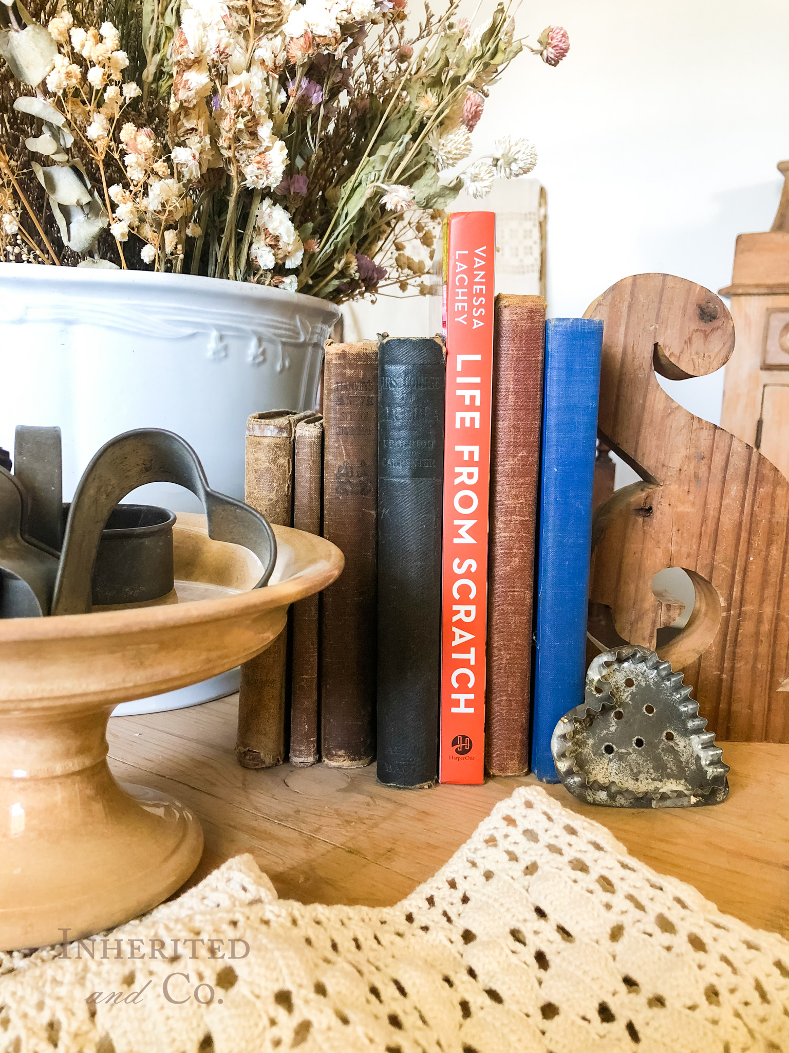 Antiques and a book stack featuring Life From Scratch by Vanessa Lachey