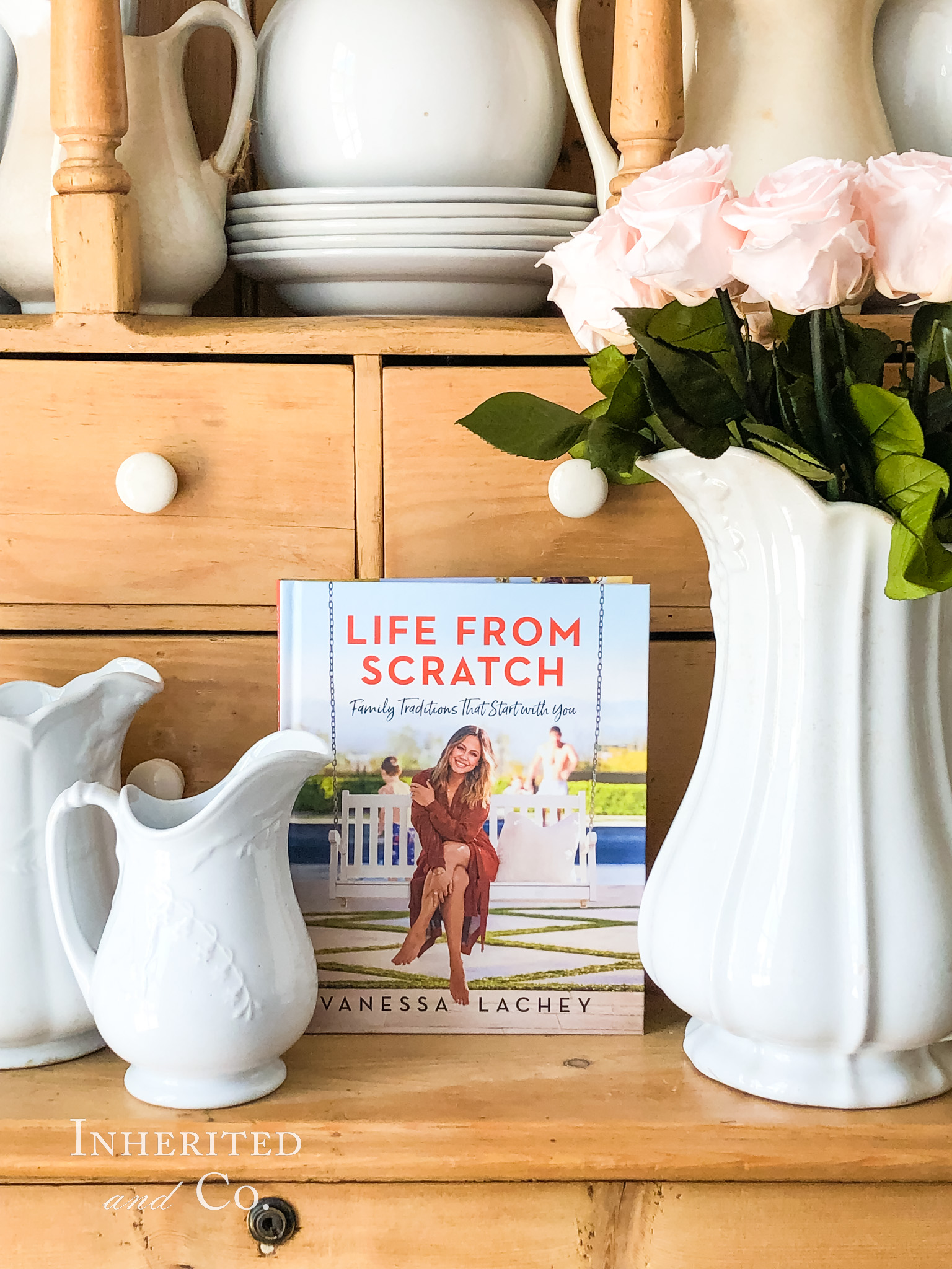 Vanessa Lachey's book, Life from Scratch, surrounded by antique ironstone and pine