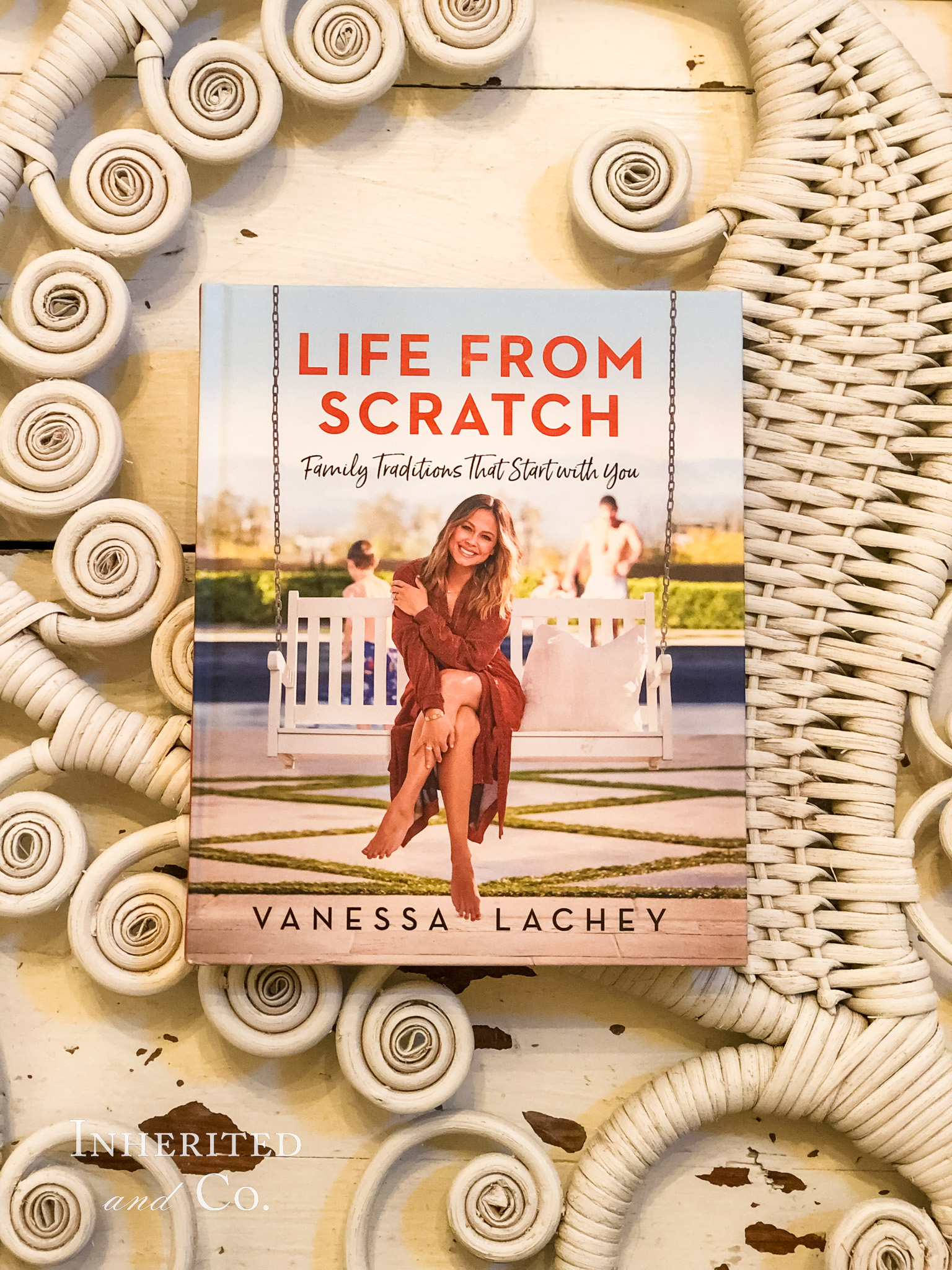 Vanessa Lachey's book, Life from Scratch, laid on vintage white wicker