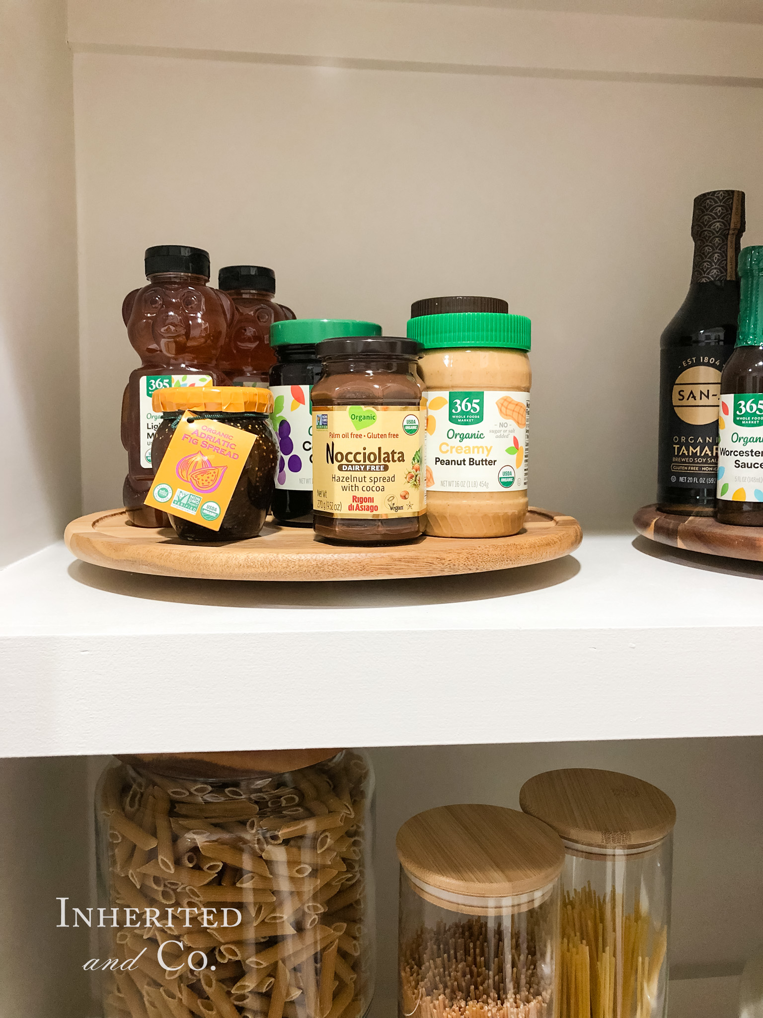 honey, peanut butter, and other spreads on an acacia lazy susan