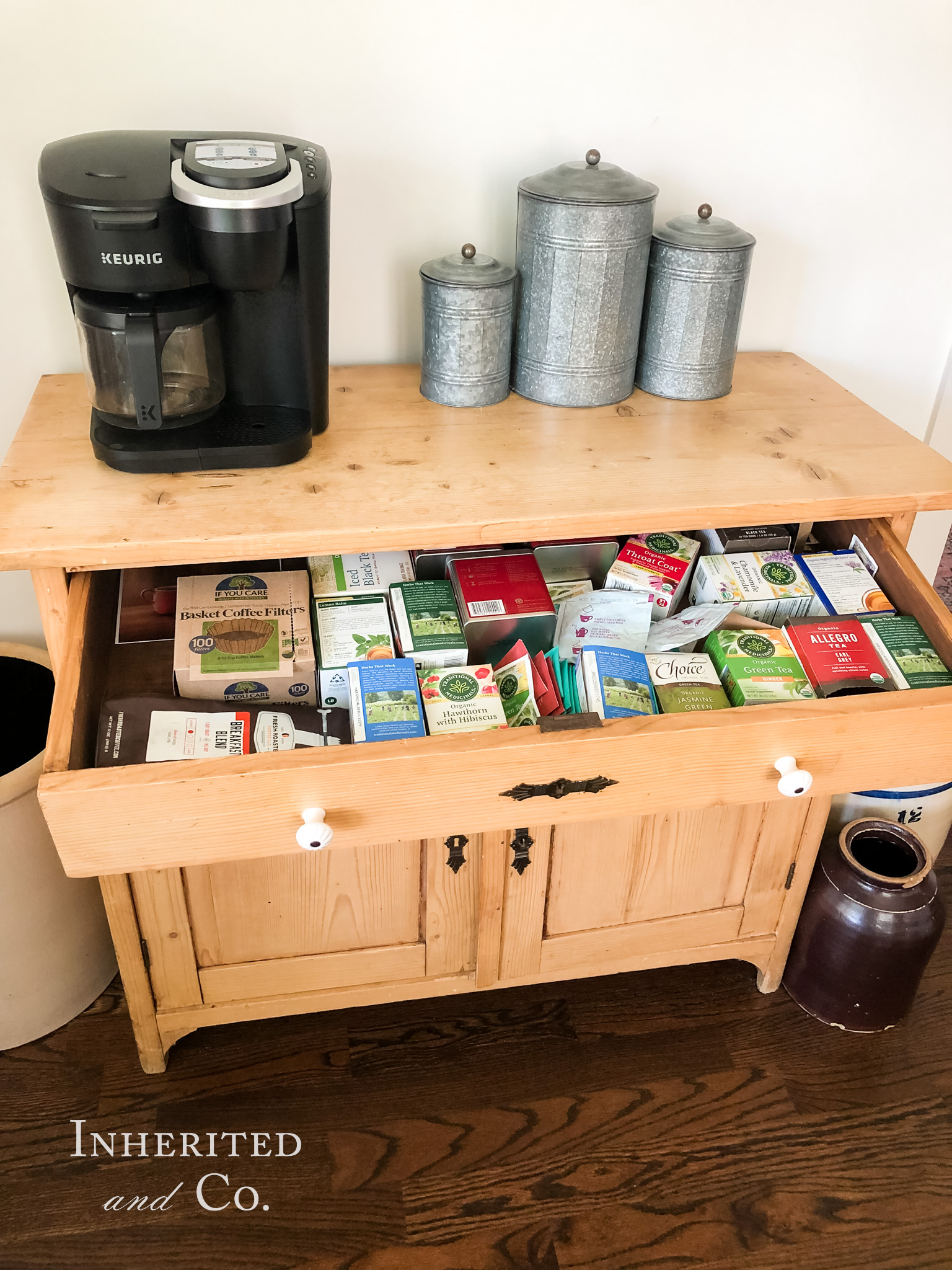 Unorganized tea drawer in an antique English pine cabinet