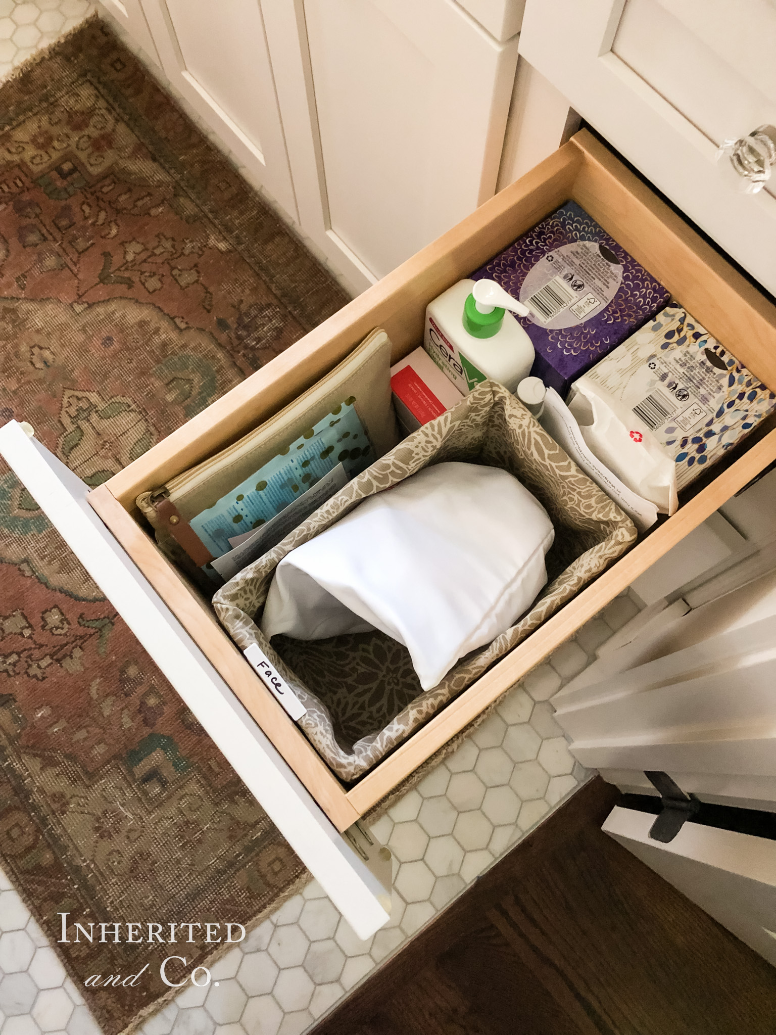 An organized bathroom vanity drawer with facial cleaning products