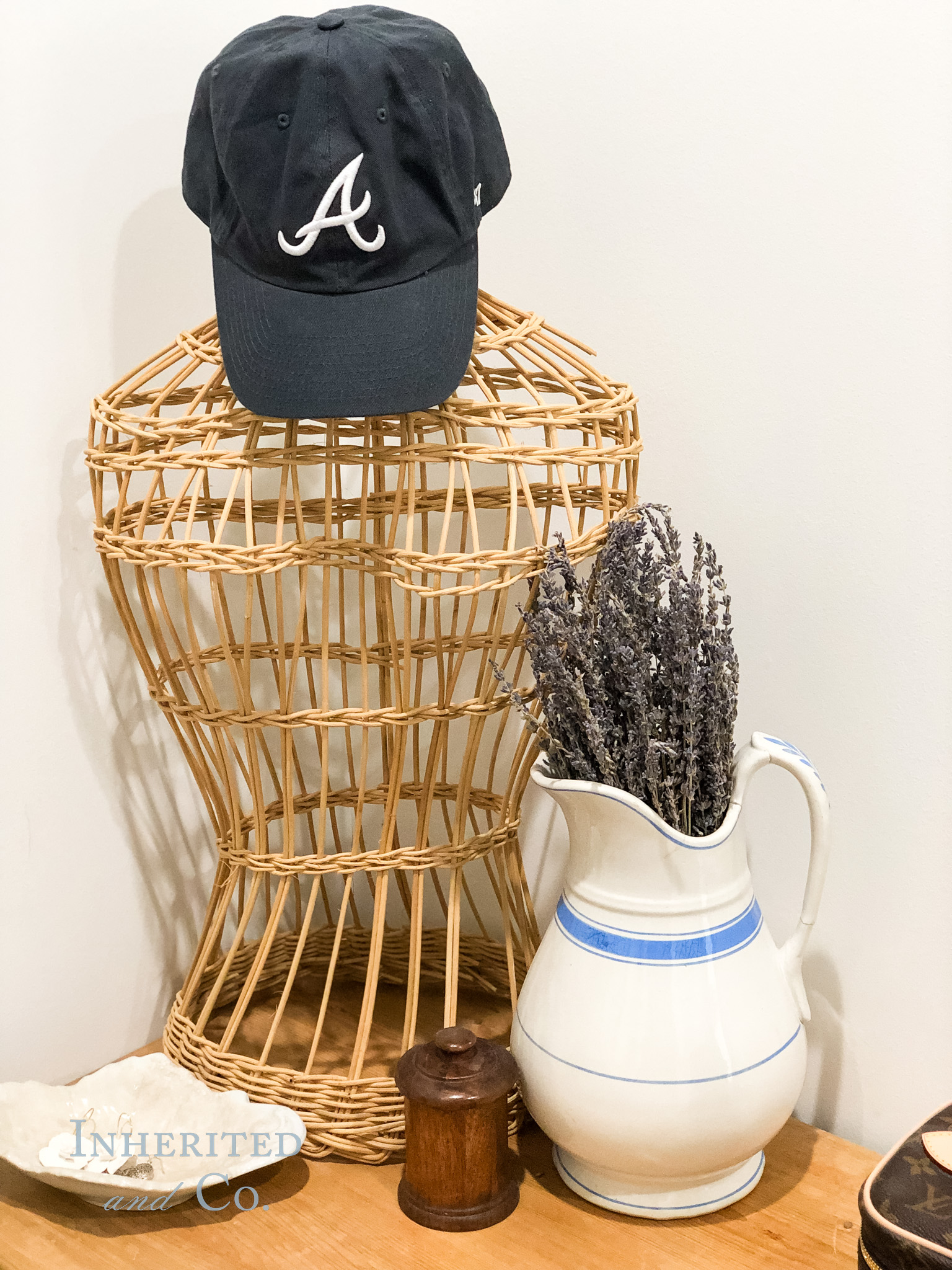 Atlanta Braves hat tossed atop a vintage wicker mannequin