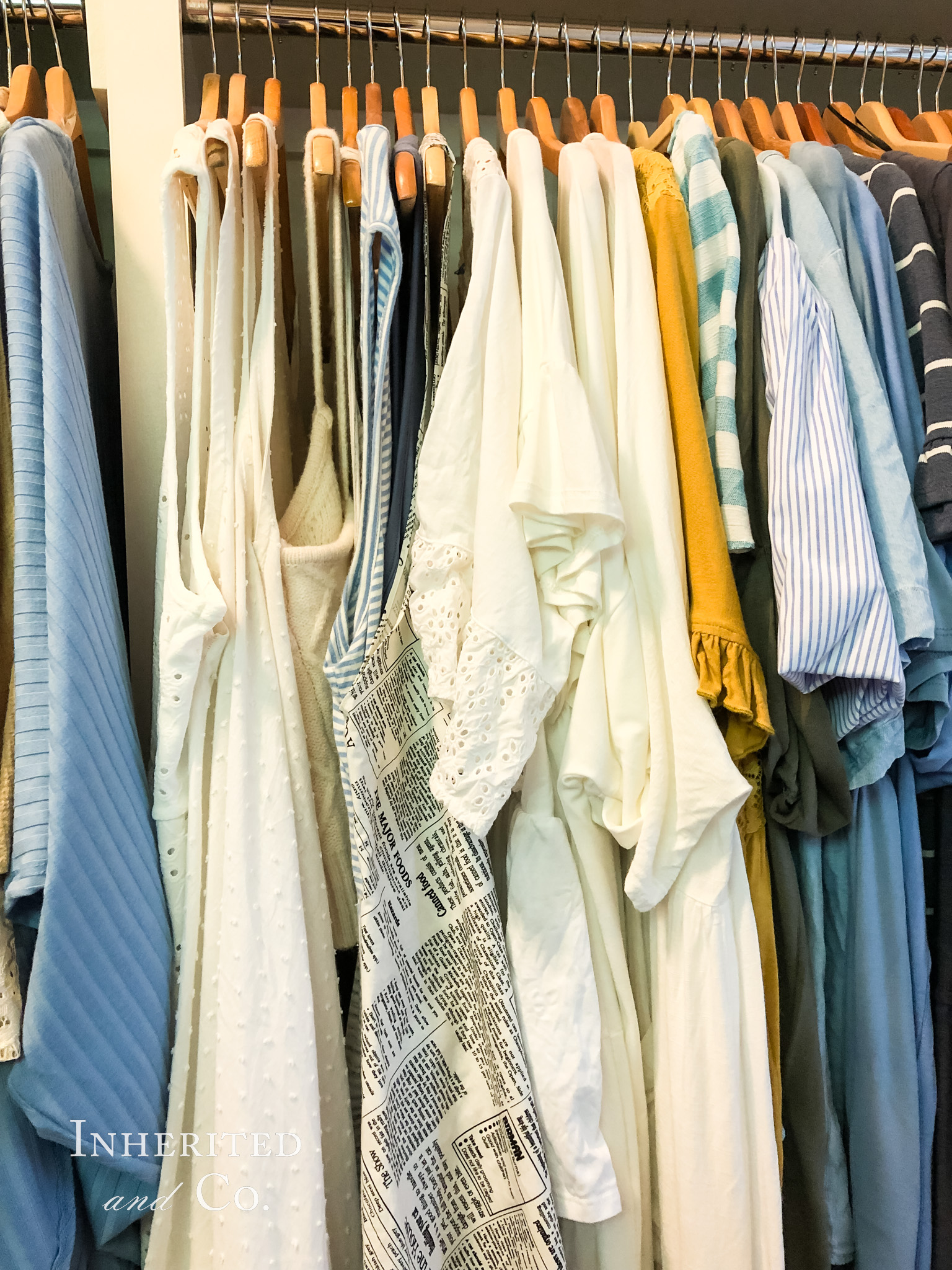 Tops arranged by color in a closet