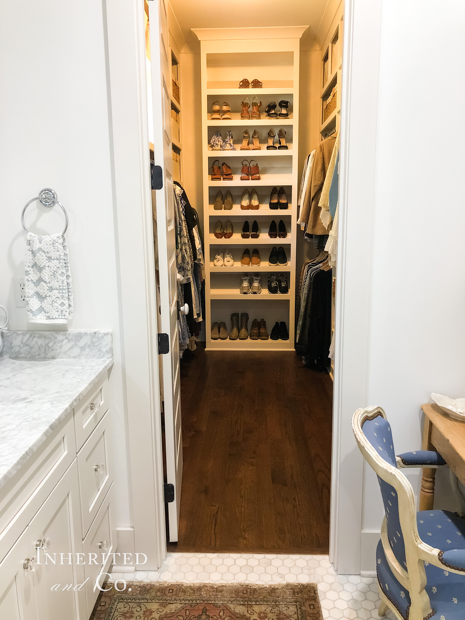 View from bathroom into an organized closet with shoe tower