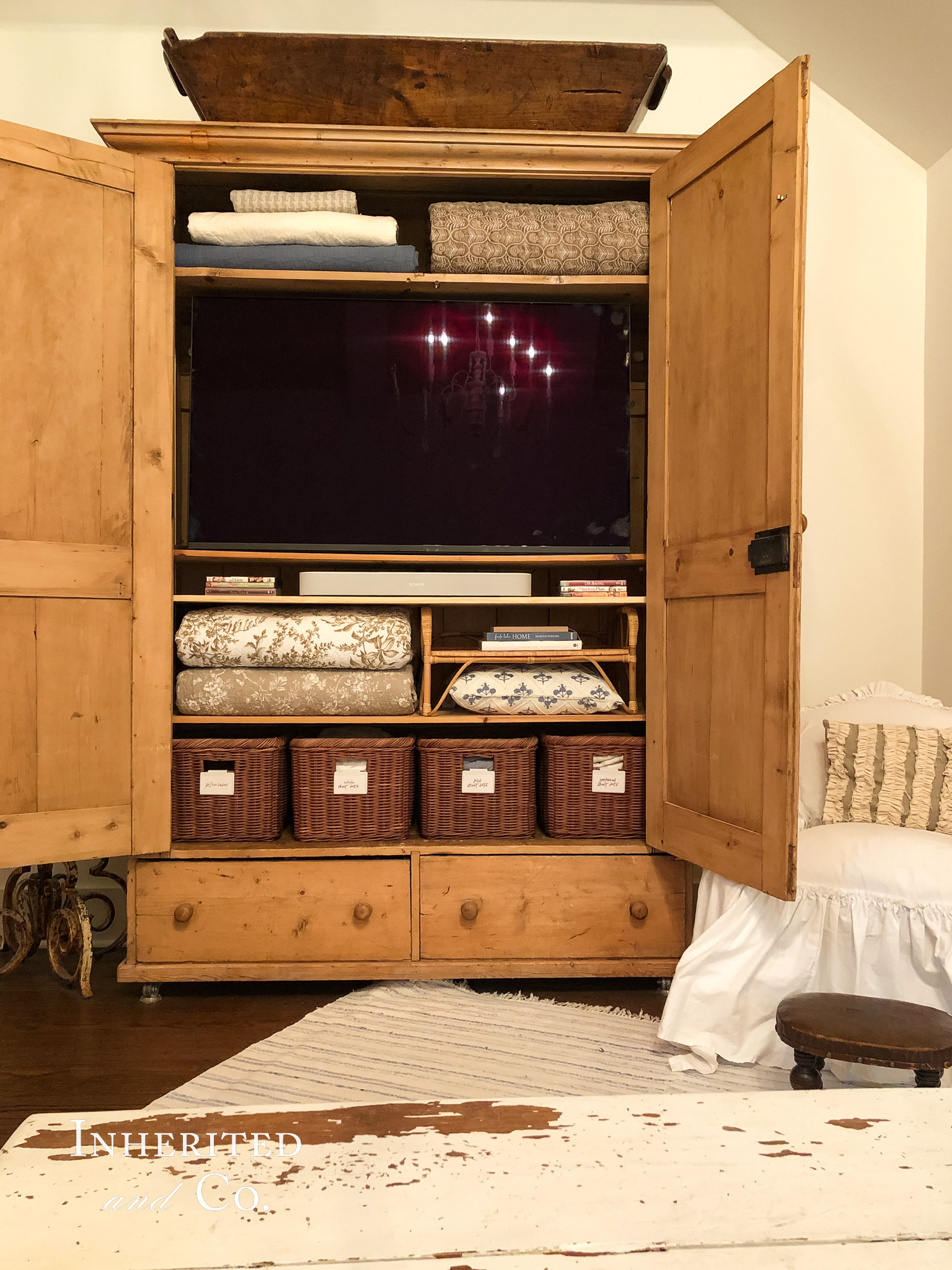 Inside of an Antique English Pine Armoire used as storage in primary bedroom