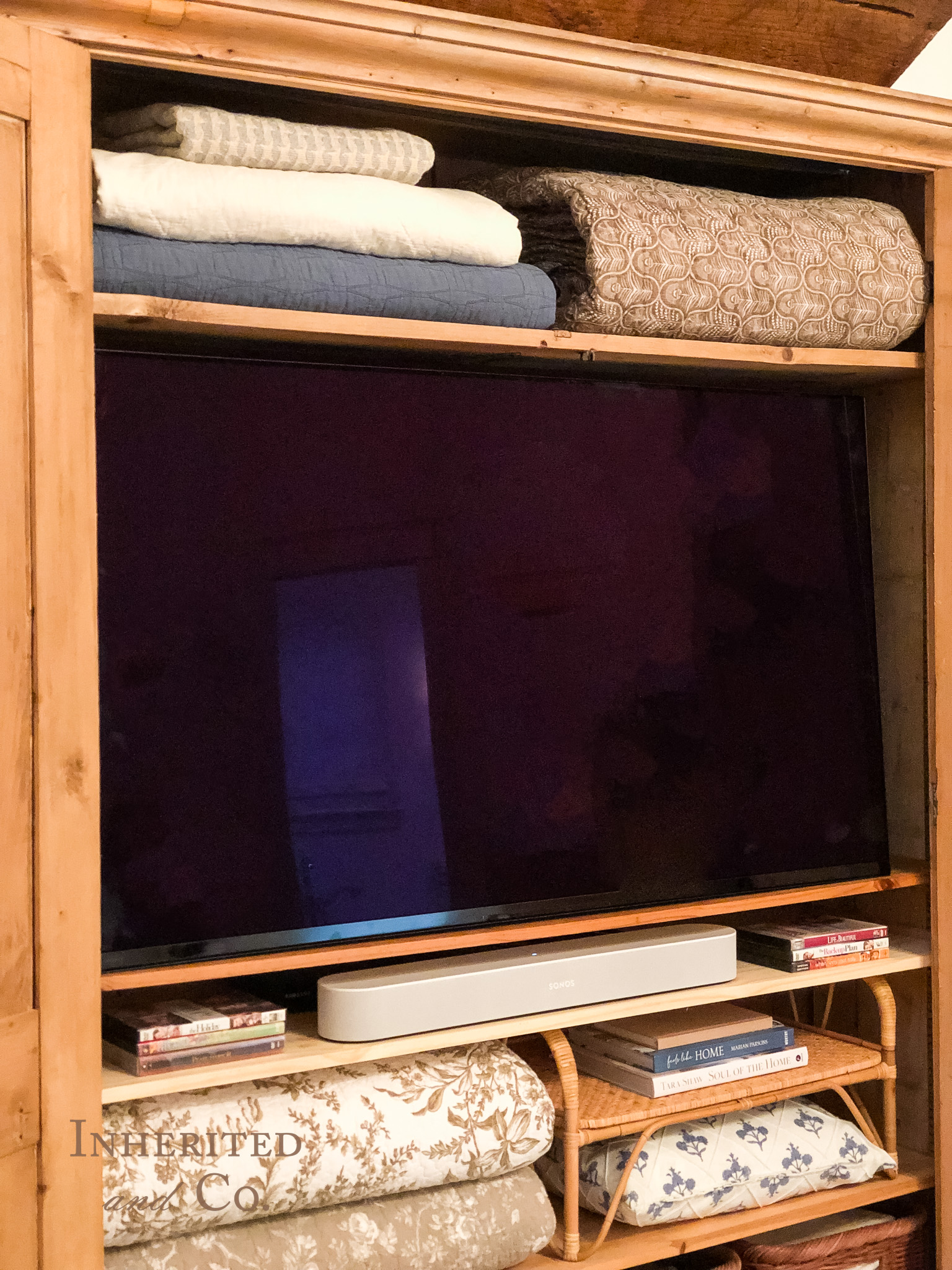 A television hidden inside of an antique armoire