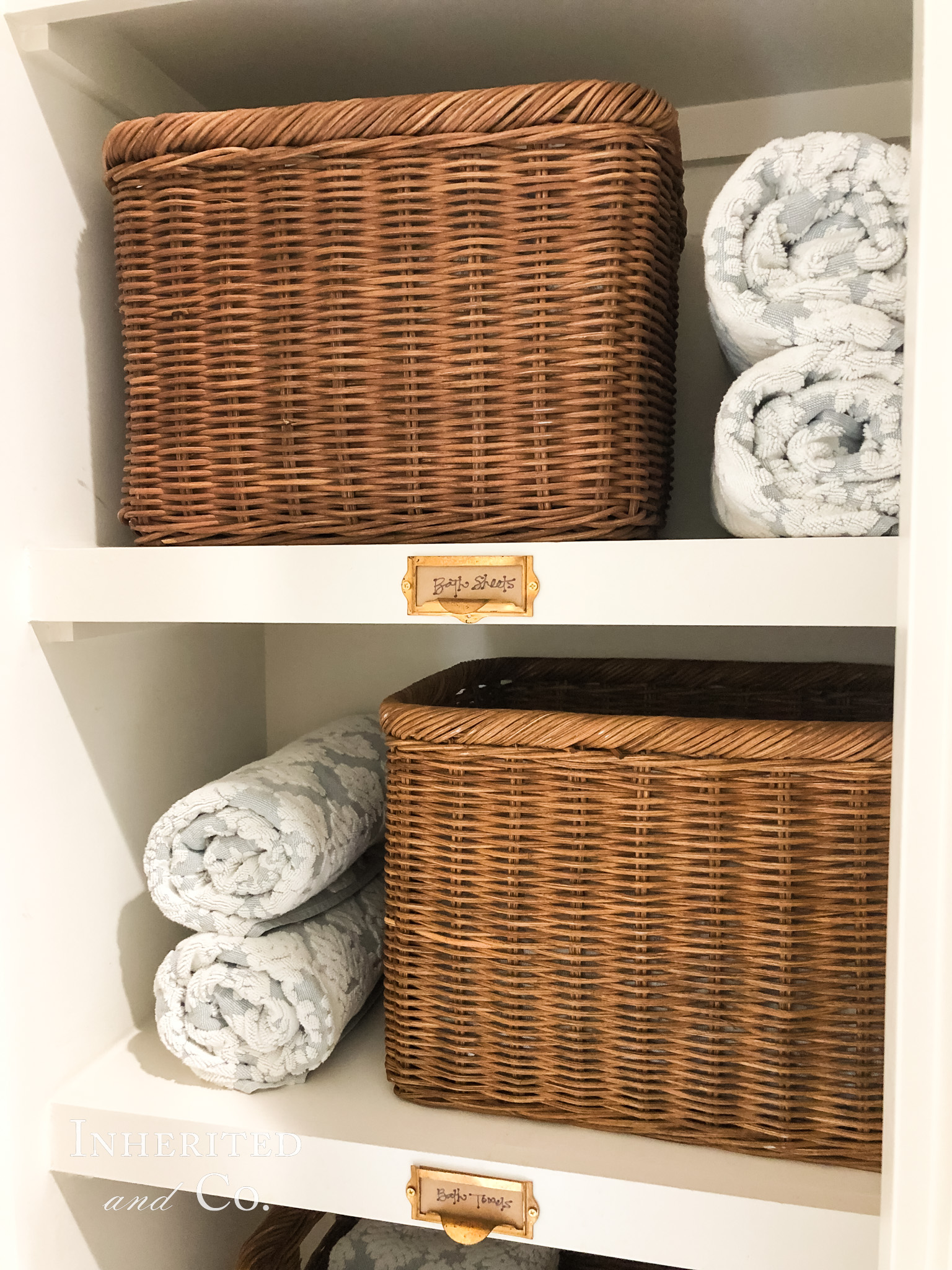 Rattan Baskets used to organize a Towel Closet