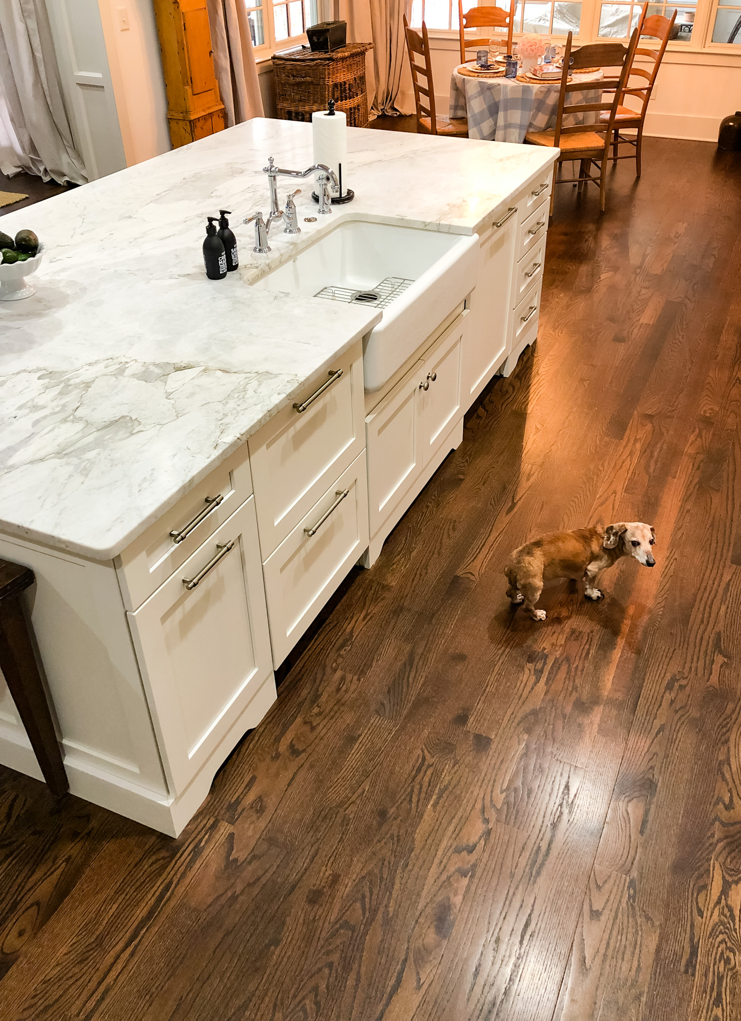 Kitchen Island designed with a marble top and white cabinets