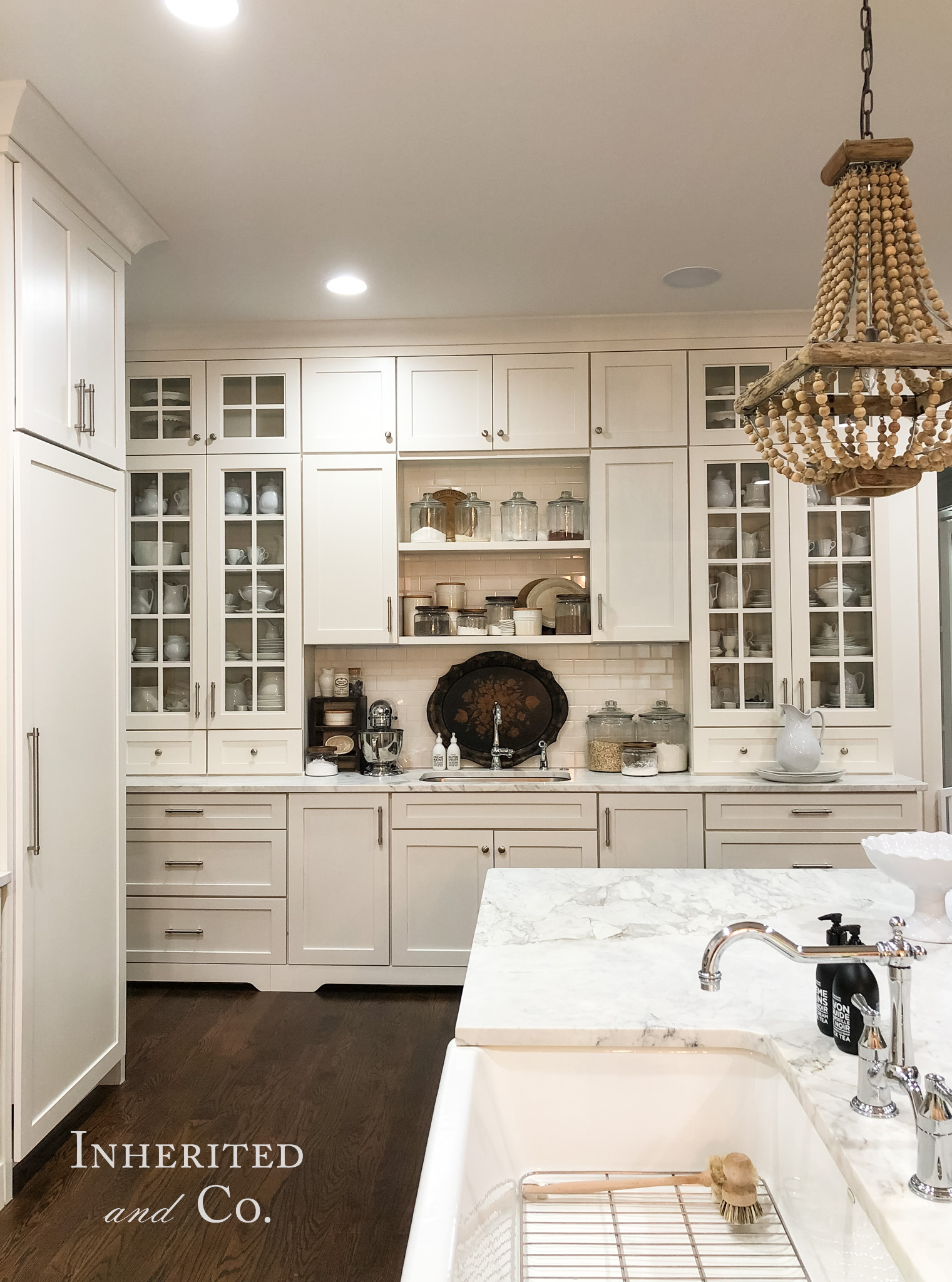 Countertop cabinets filled with antique ironstone in a custom kitchen